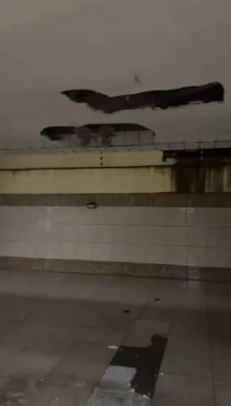 Buracos abertos no teto da garagem para tentar conter vazamento de água no edifício Gentil Linhares