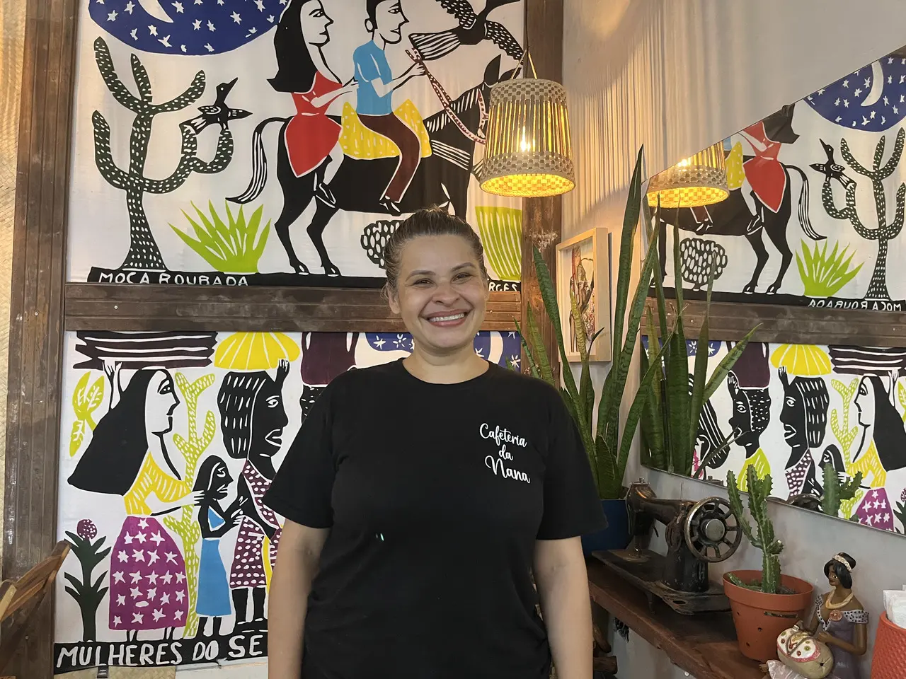 Mulher branca de camisa preta sorrindo