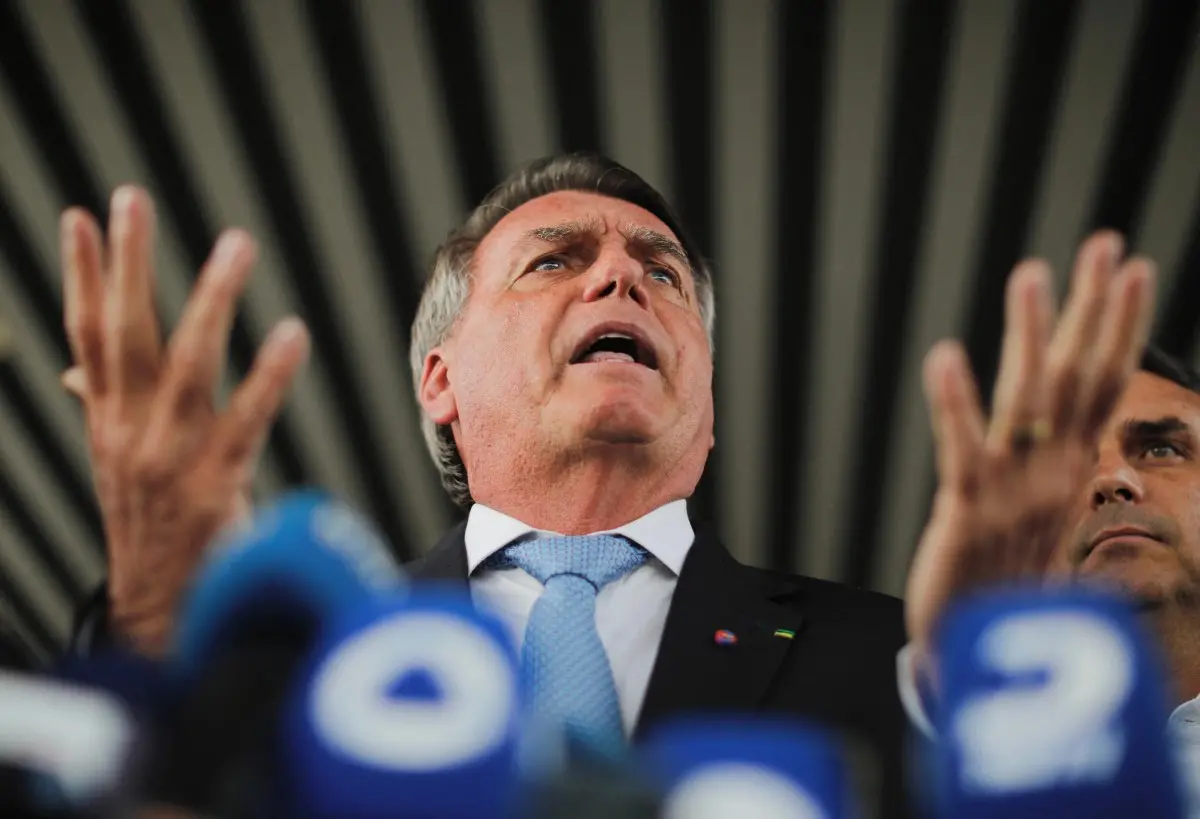Bolsonaro gesticula com as mãos para o alto durante entrevista coletiva
