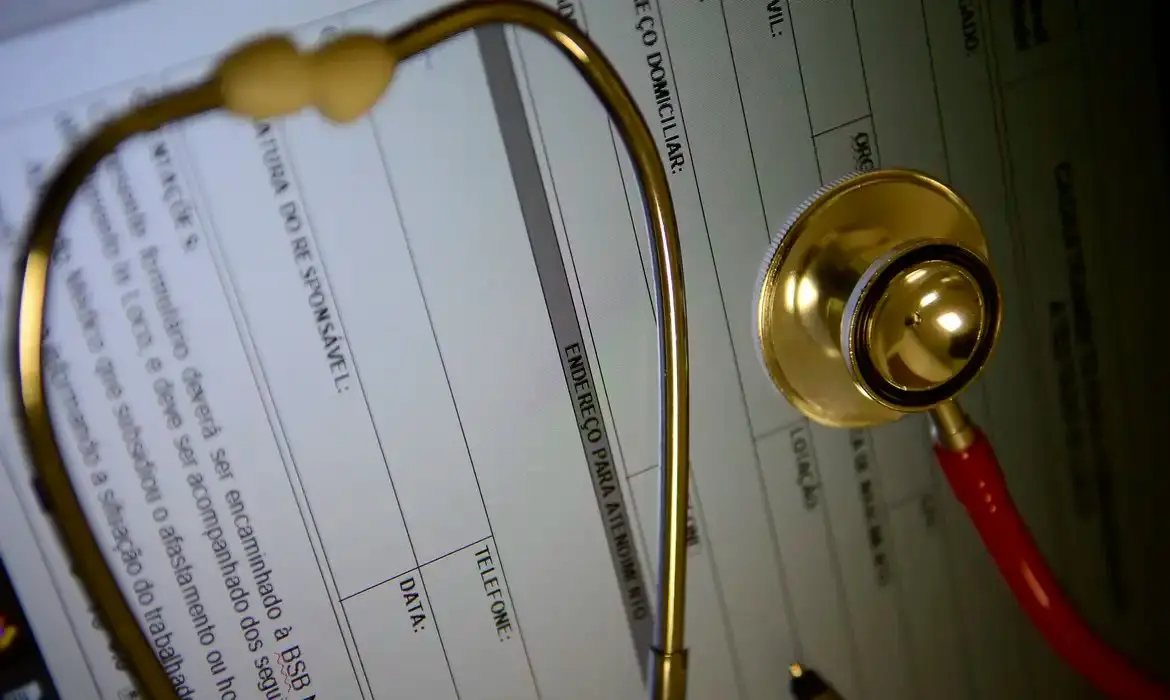 Documento com estetoscópio médico em cima para ilustrar reportagem sobre planos de saúde.