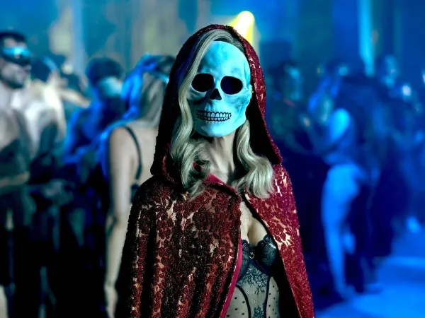 Sexy e sombria, Verna  (Kate Siegel) sempre está presente durante os  acontecimentos mais chocantes. A personagem faz alusão ao conto “A Máscara da Morte Rubra”