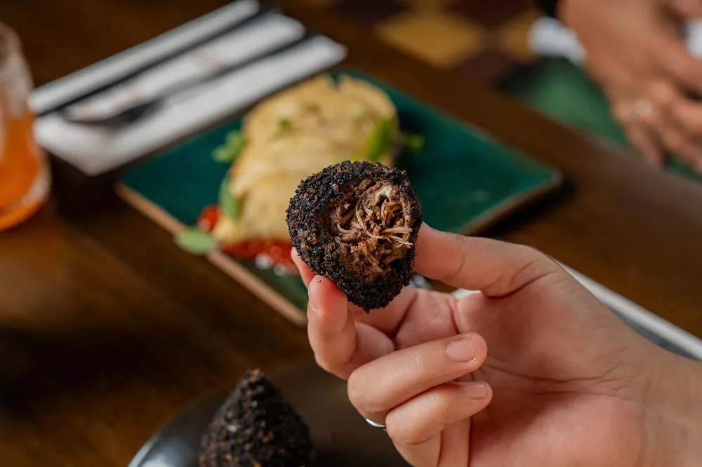 Massa da coxinha de cabidela é com molho pardo – o que explica a coloração preta do salgado